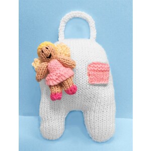 May include: A white knitted toy with a handle, a pink pocket, and a small angel doll attached. The angel has blonde hair, tan skin, and a pink dress. The background is a light blue.