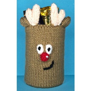 May include: A knitted reindeer gift bag with a brown body, white antlers, black eyes, a red nose, and a black smile. The bag is filled with chocolate bars.