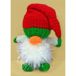 May include: A knitted gnome toy with a red hat, green body, white beard, and orange nose.
