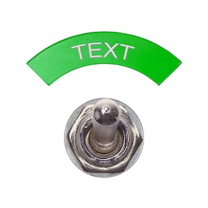 May include: A green toggle switch with the word "TEXT" written on it. The switch is in the off position.