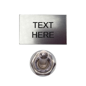 May include: A silver toggle switch with a rectangular label that reads "TEXT HERE".