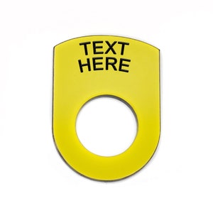 May include: Yellow plastic push button with a round hole in the centre. The button has the text "TEXT HERE" printed on it.