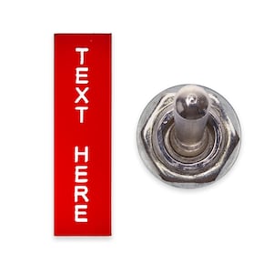 Puede incluir: Un interruptor de palanca rectangular rojo con el texto "TEXT HERE" en letras blancas. El interruptor está en posición de apagado.