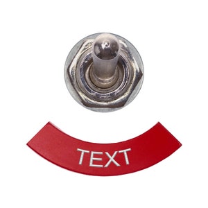 以下が含まれることがあります： 白い文字で「TEXT」と印刷された赤いトグルスイッチです。