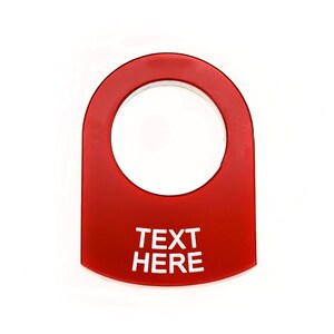 May include: Red plastic toggle switch cover with a round hole and the text "TEXT HERE" in white.