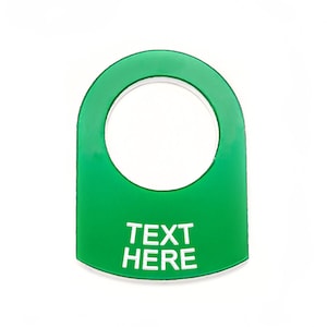May include: Green plastic button with a round hole in the center and the text "TEXT HERE" in white.