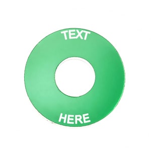 May include: A green round button with a hole in the centre. The button has white text that says "TEXT HERE".