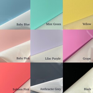 May include: Nine color swatches of acrylic paint in various shades of blue, green, yellow, pink, purple, and grey. The colors are arranged in a 3x3 grid.