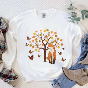 Cute fall tree, monarch butterflies and a fox looking at the butterflies make this fall sweatshirt a favorite this season. great gift for nature lovers, Xmas gift.