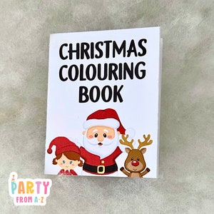 May include: A white colouring book with the text "CHRISTMAS COLOURING BOOK" in black. The cover features a cartoon illustration of Santa Claus, an elf, and a reindeer.