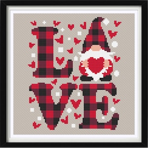 May include: Cross stitch pattern featuring the word "LOVE" in red and black buffalo plaid with a gnome holding a red heart in the center. The background is a light beige with small white and red hearts.