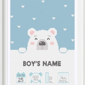 May include: A blue and white cross-stitch design featuring a white polar bear peeking over a white banner. The banner reads "BOY'S NAME". Below the banner are four icons: a calendar with the date 05/19 and the number 25, a clock with the time 2:50 AM, a ruler with the number 19 in., and a scale with the numbers 7 lbs. and 6 ozs.