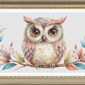 May include: A watercolor painting of a cute owl with pink and blue feathers sitting on a branch with colorful leaves. The owl has big brown eyes and a white belly.