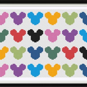 May include: A framed cross-stitch artwork featuring a grid of colorful Mickey Mouse head silhouettes. The design includes various colors like pink, purple, blue, orange, green, and black, set against a white background. The frame is black.