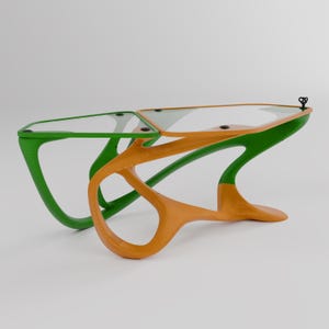 May include: A modern coffee table with a unique, organic design. The table has two glass tops and a base made of two different colors: green and orange.