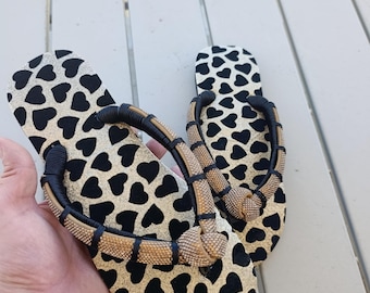 Customized Havaianas with an animal print and crystal embellishments. Women's beachwear.