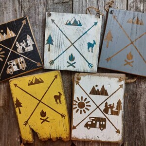Wood sign &quot;Camping in the PNW&quot; motorhome, mountains, trees, lake, campfire, deer,arrow