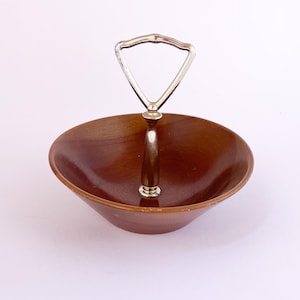 MCM walnut trinket/serving bowl with metal handle. Mid-century home decor piece.