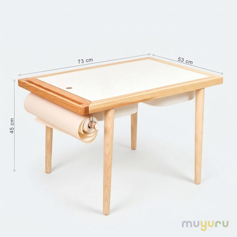 May include: A wooden art table with a white surface and a roll of paper. The table is 28.7 inches long, 20.9 inches wide, and 17.7 inches high. The table has a natural wood frame and legs, and a built-in paper roll holder.