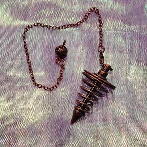 Divinatory pendulum, spiral metal pendulum, radiesthesia, esotericism, divinatory arts, wicca, magical tools