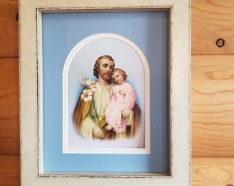 Saint Joseph and the child Jesus framed print