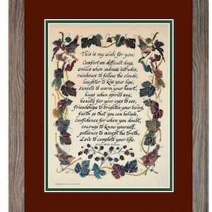 Puede incluir: Obra de arte enmarcada con un marco de madera marr&oacute;n y gris. La obra presenta un poema escrito a mano con p&aacute;jaros y follaje decorativos. El texto dice "This is my wish for you..." y contin&uacute;a con versos inspiradores. La obra de arte est&aacute; sobre un fondo blanco y rojo oscuro.