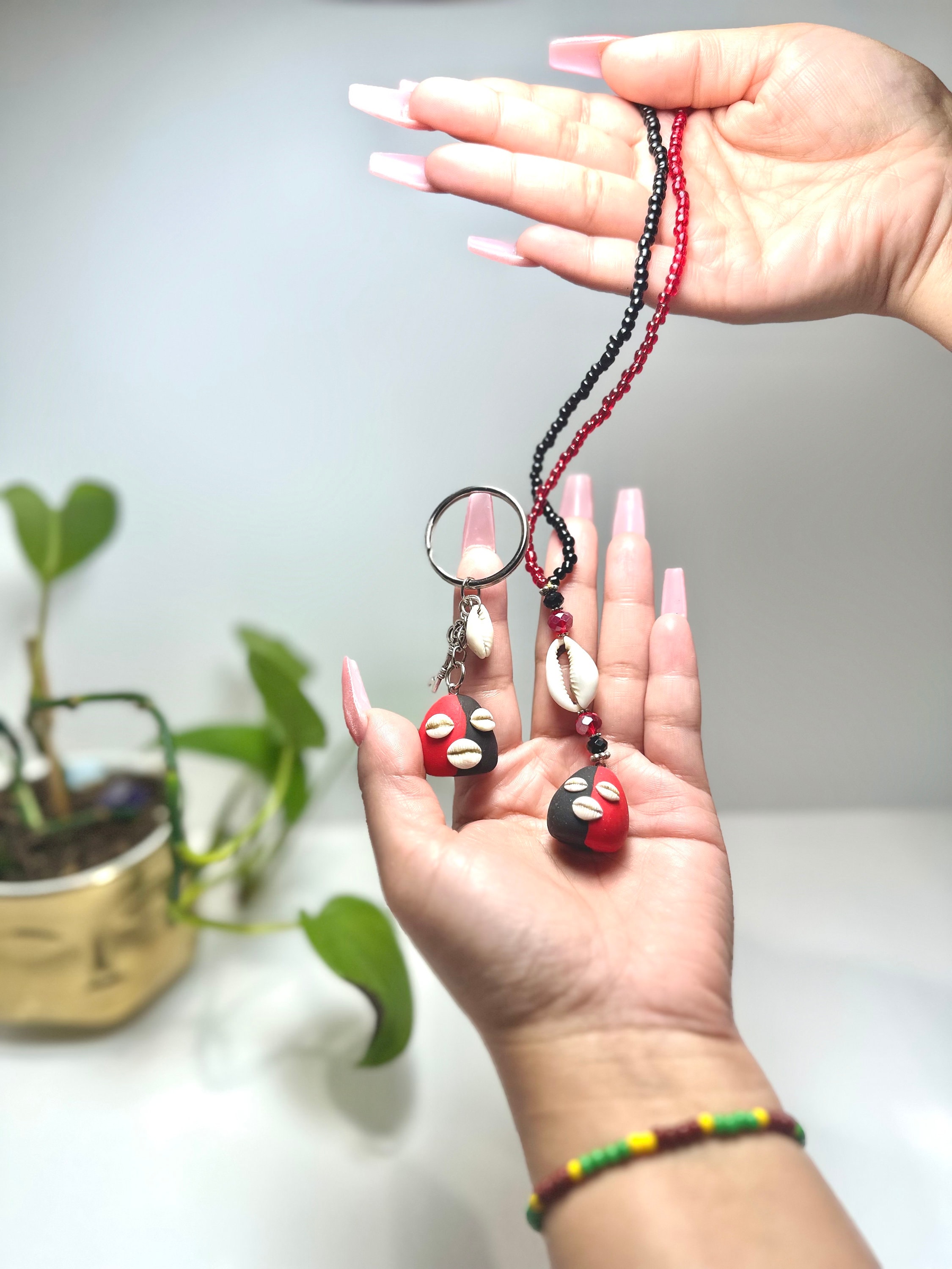Eleggua rear view mirror amulet and matching keychain.