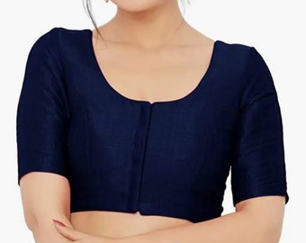 May include: A navy blue sleeveless blouse with a round neckline and a button closure in the front.