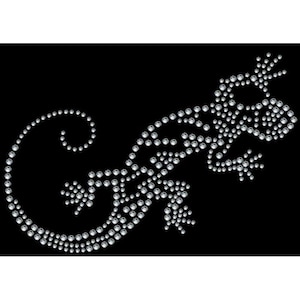 Könnte beinhalten: Ein silbernes Strass-Design eines Leguan auf schwarzem Hintergrund.