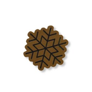 May include: A brown snowflake-shaped coaster with a black geometric design. The coaster has a scalloped edge and is set against a white background. This decorative item is suitable for winter or holiday decor.