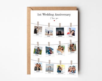 May include: A white card with a photo collage of a couple's wedding anniversary. The card has the text "1st Wedding Anniversary" and "I love you" with a small red heart. The photos are arranged in a grid of twelve, with each photo labeled with a number from one to twelve.