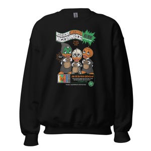 May include: Black sweatshirt with a graphic of three cartoon ducks wearing Halloween costumes. The graphic says "Not So Scary Halloween Magic Shamrock" and "All New! Exclusive Halloween Masks".
