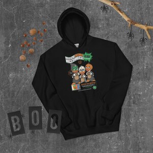 May include: Black hoodie with a graphic of three cartoon ducks wearing pumpkin hats. The graphic says "World Series Macho Shamrocks" and "All New!" The hoodie has a drawstring hood and a kangaroo pocket.
