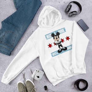 May include: White hooded sweatshirt featuring a graphic of Mickey Mouse in a punk rock style. The graphic includes the text "Mickey Punk" and "Best of the World".