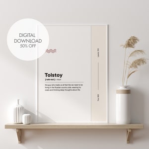 May include: A framed print with the name "Tolstoy" in a minimalist design. The print includes a definition of Tolstoy, a red wave graphic, and the text "DIGITAL DOWNLOAD 50% OFF". The print is displayed on a wooden shelf.