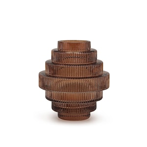 May include: A brown glass vase with a stacked, tiered design. The vase has a ribbed texture and a cylindrical shape, with each tier slightly wider than the one above. The vase is approximately 10 inches tall.