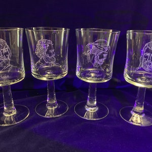 May include: Four clear glass wine glasses with etched portraits of men and their names. The names are John, Jake, James (the Tiger), and James son of Zebedee.