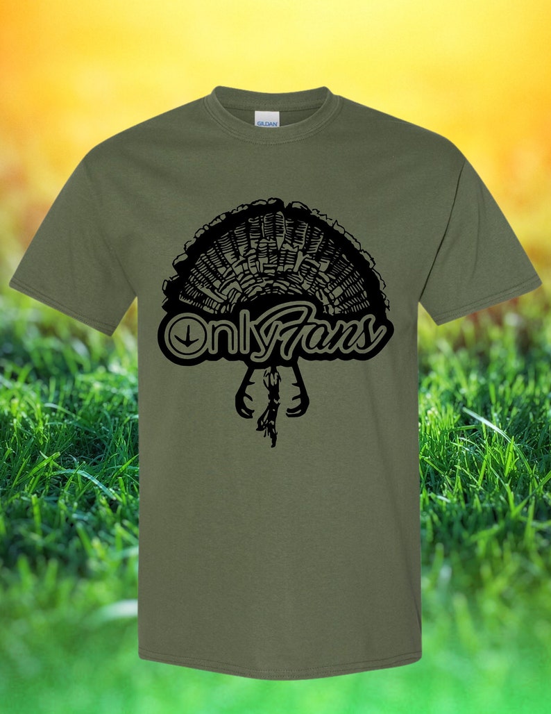 May include: A green t-shirt featuring a black graphic of a turkey with the text "Only Fans" underneath.
