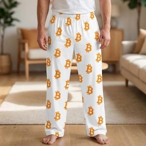 May include: White pajama pants with an all-over pattern of orange Bitcoin symbols. The pants have a relaxed fit and a comfortable waistband. The Bitcoin symbols are evenly spaced across the fabric.