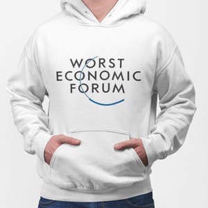 May include: White hooded sweatshirt with the text "WORST ECONOMIC FORUM" in black letters and a blue graphic. The sweatshirt has a front pocket and a drawstring hood. The person in the image is wearing blue jeans.