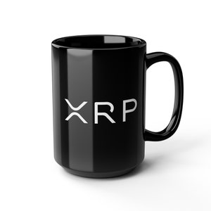 May include: A glossy black ceramic mug featuring the white XRP logo printed on the front. The mug has a cylindrical body with a curved handle on the right side. The surface of the mug is smooth and reflective, showcasing the bold white lettering.