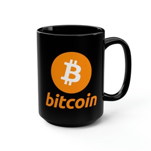 May include: Black ceramic mug with a bright orange circle containing a white Bitcoin symbol and the word "bitcoin" in orange letters.
