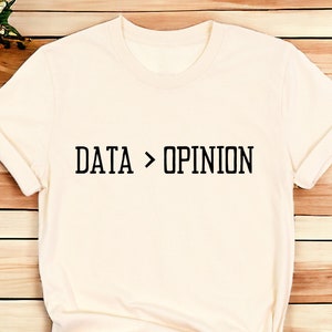 May include: A white t-shirt with the text "DATA > OPINION" printed in black.