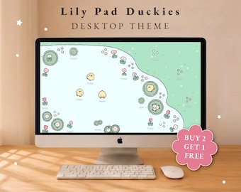 May include: A computer monitor displaying a Lily Pad Duckies desktop theme with a light green and blue pond background featuring yellow ducklings, lily pads, and small pink flowers. The screen text reads Lily Pad Duckies DESKTOP THEME.