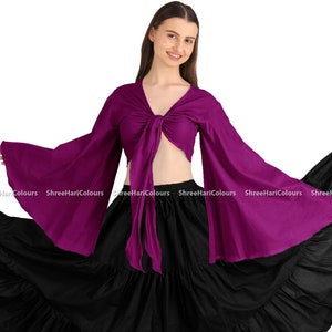 May include: A two-piece dance costume featuring a deep purple tie-front top with long, flared sleeves and a flowing black tiered skirt. The top ties at the waist, and the skirt has a wide, ruffled hemline. The outfit is designed for dance or performance.