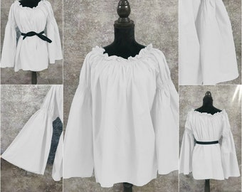 May include: White peasant top with long, flowing sleeves and a gathered neckline. The top is made of a lightweight fabric and has a relaxed fit.
