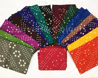 May include: A collection of 16 colorful fabric squares with a white polka dot pattern. The squares are arranged in a semi-circle, with the darkest colors at the top and the lightest colors at the bottom.