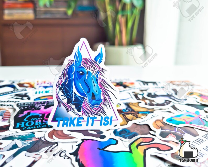 May include: A blue and purple horse head sticker with a triangle border and the text "TAKE IT ISI" on a white background. The sticker is surrounded by other stickers.