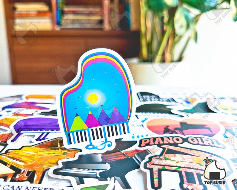May include: A collection of colorful piano-themed stickers, including a sticker of a piano with a mountain scene and a sticker of a piano with the text "Piano Girl".