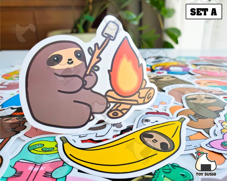 May include: A set of stickers featuring cute cartoon sloths. The stickers include a sloth roasting marshmallows over a campfire, a sloth eating a banana, and a sloth holding a book. The stickers are perfect for adding a touch of whimsy to your laptop, water bottle, or planner.